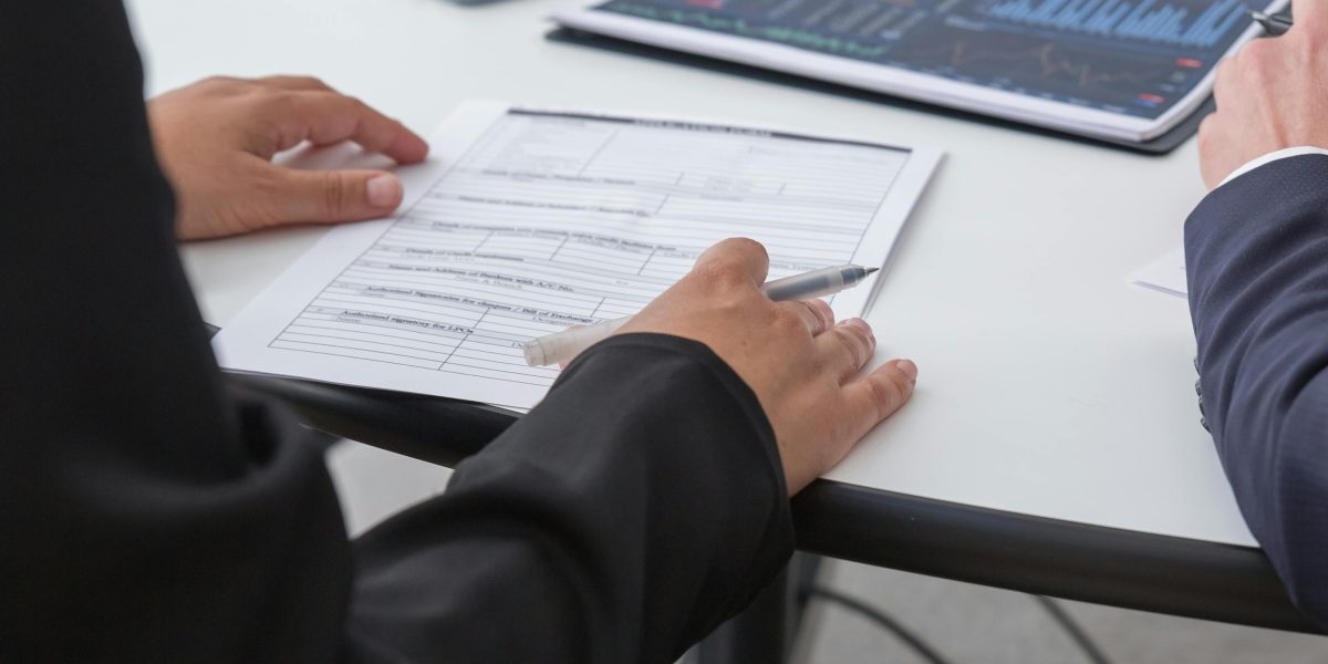 An individual meticulously reviewing documents, symbolizing the critical consideration of privacy and security in AI tool adoption.