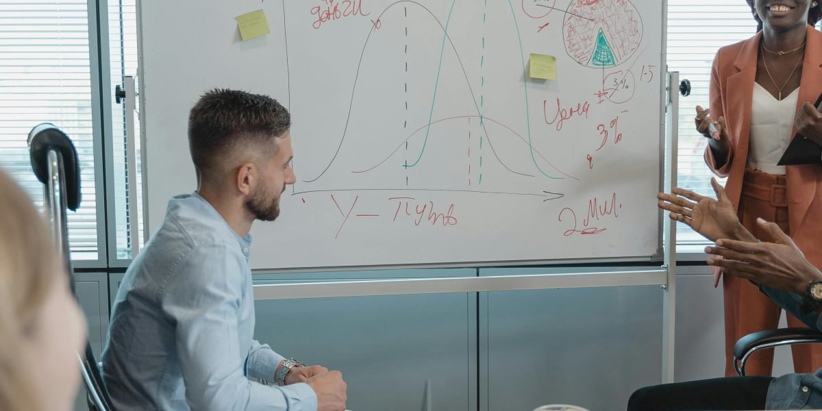 A team collaborates in an office setting, brainstorming ideas on a whiteboard, symbolizing innovation and importance in the AI landscape.