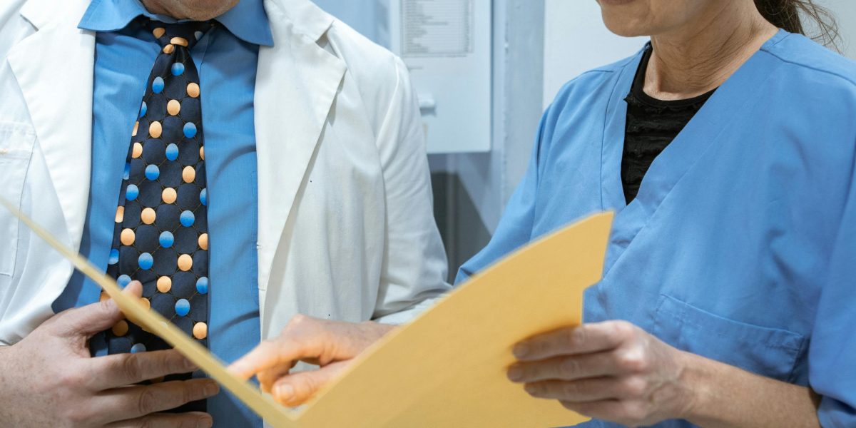 A team of professionals reviewing a document or checklist, ensuring consistent application of guidelines and terminology.