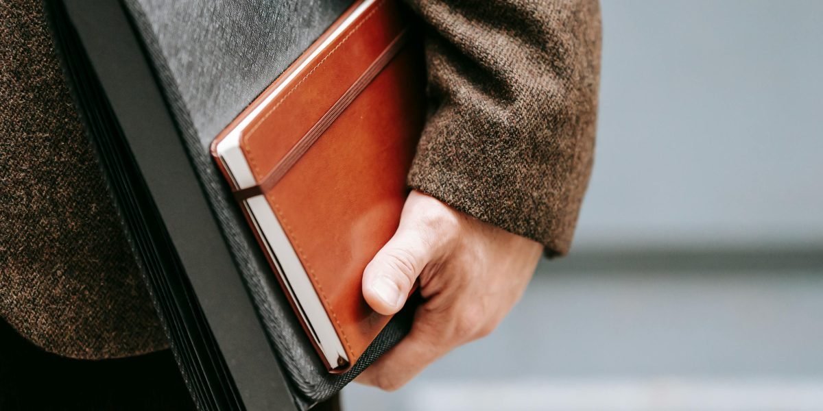 A person confidently presents a professional portfolio, highlighting the importance of practical project evidence over traditional credentials in AI.