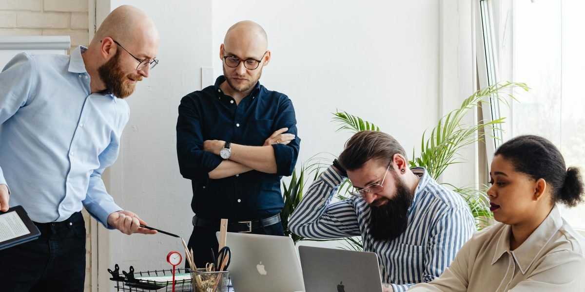A diverse group of professionals collaborating in an office setting, representing the varied stakeholders in the AI ecosystem.