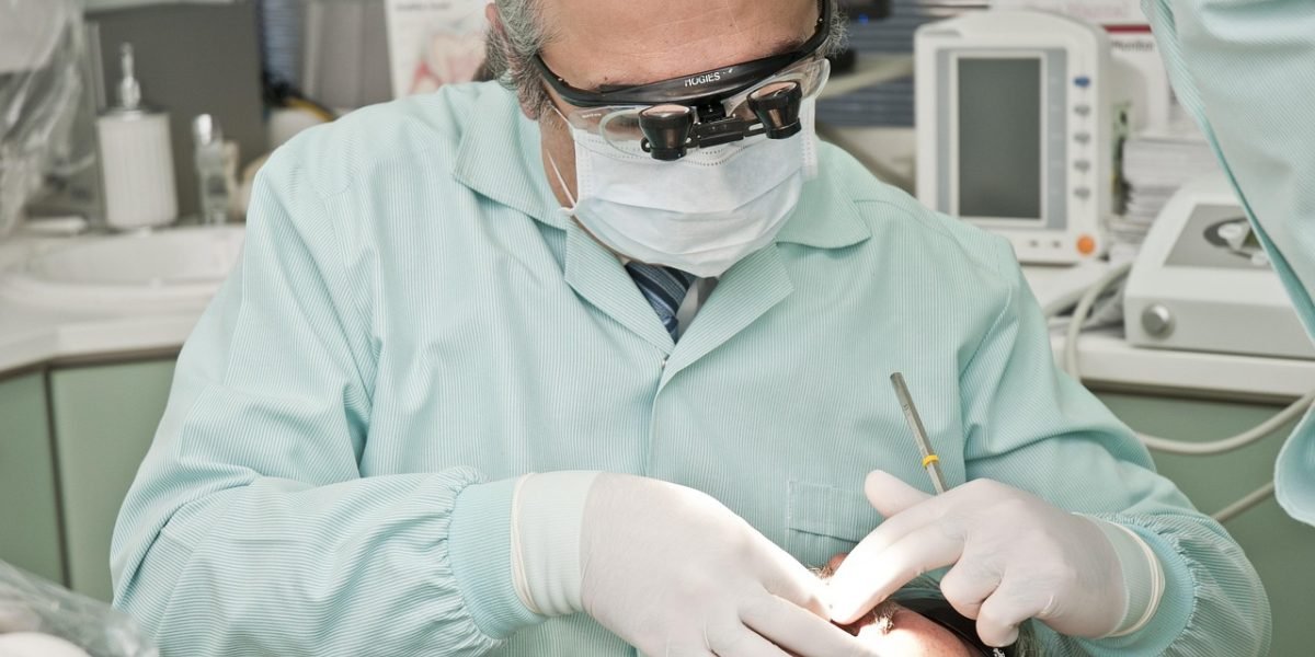 Medical students or professionals engaged in a hands-on learning environment, potentially using a simulator or model for practice.