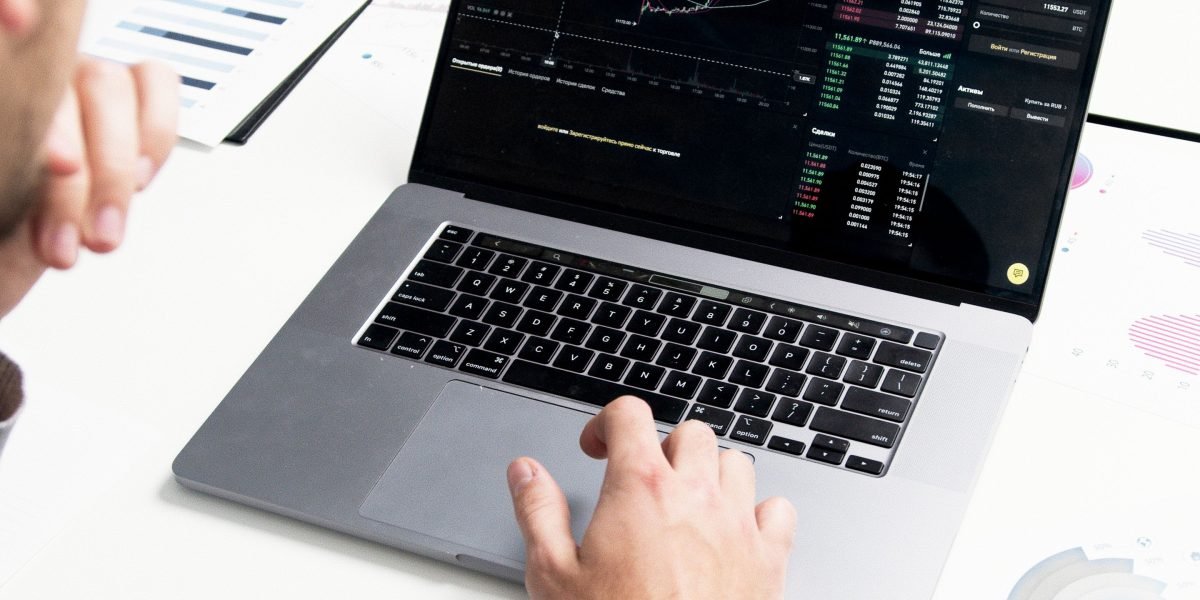 A professional focuses intently, sifting through data to find clarity amidst information overload.