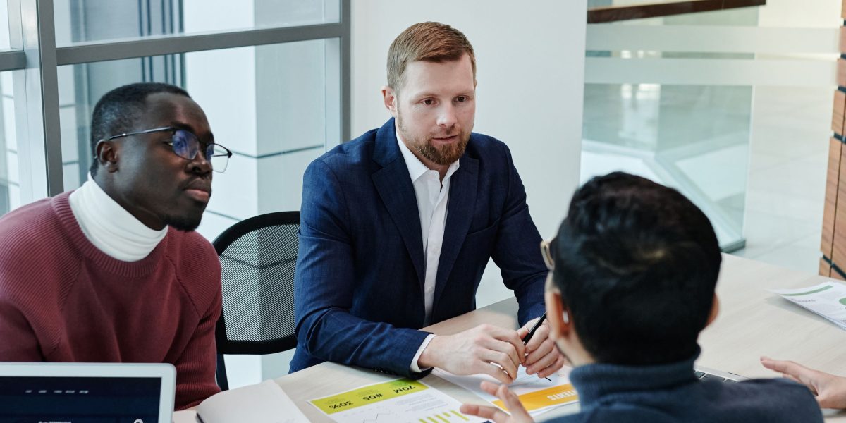 A diverse team holds an engaged discussion, addressing the ethical implications and challenges of AI technology.