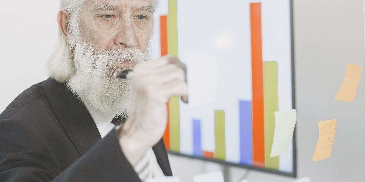 A business leader reviews financial charts, illustrating the significant cost savings achievable through power efficiency in AI infrastructure.