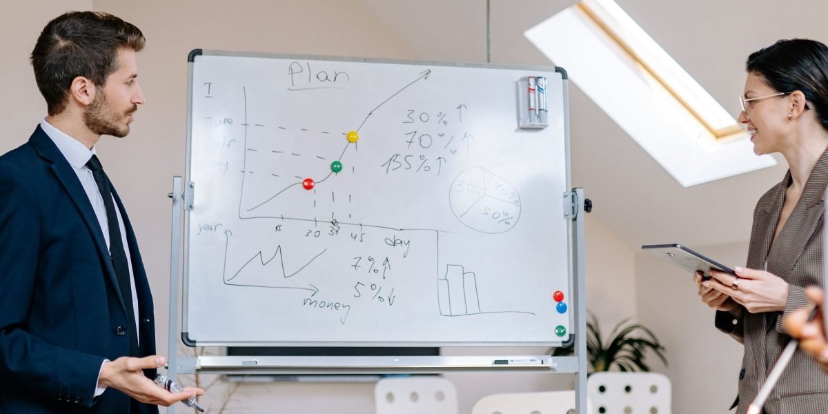 A team of professionals collaborating, discussing strategy to avoid costly mistakes in project planning.