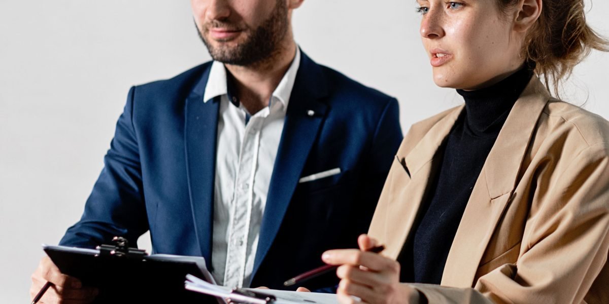 Two professionals engaged in a thoughtful discussion, emphasizing the need for clarity and understanding intent beyond surface-level information.
