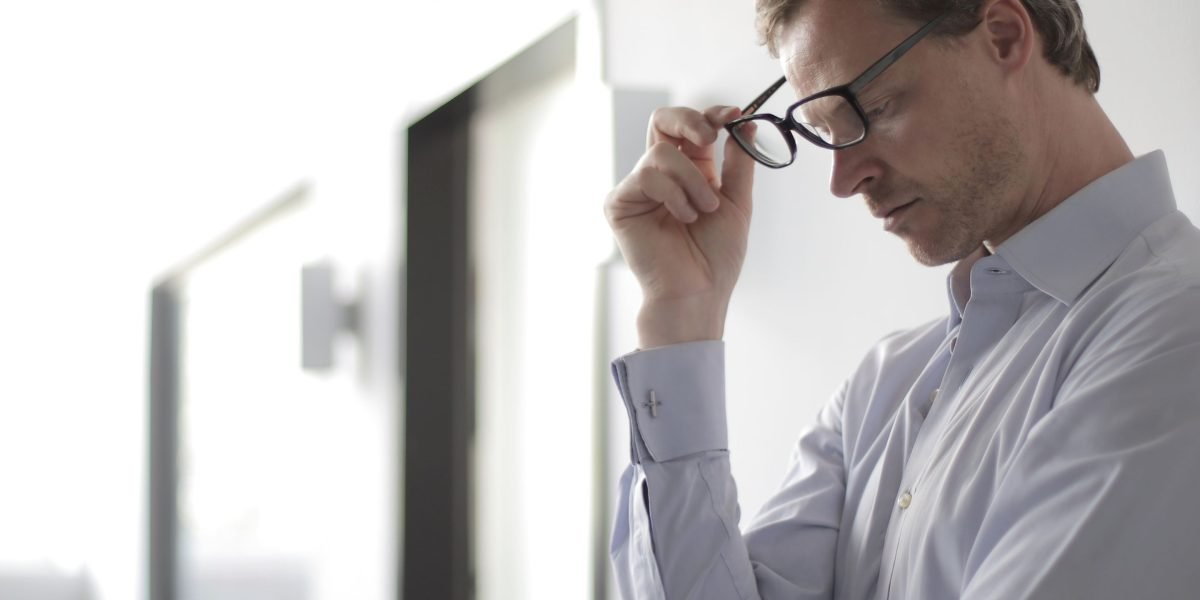 A person carefully considers options, representing the thoughtful process of evaluating and selecting an AI story writing tool.