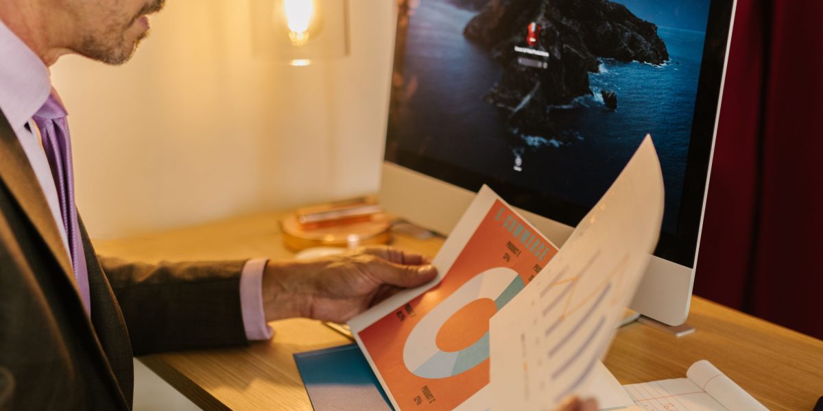 An individual diligently reviewing data, demonstrating the importance of measuring impact to refine future infographic strategies.
