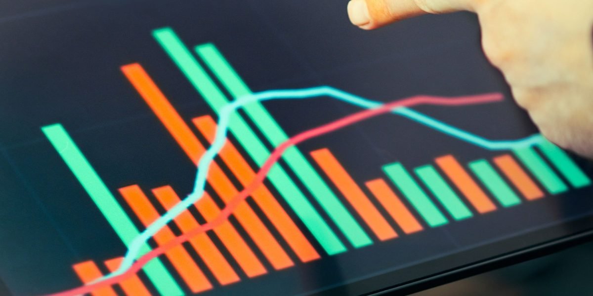 A person intently reviewing complex market data, symbolizing the challenge of discerning valuable insights from vast information.