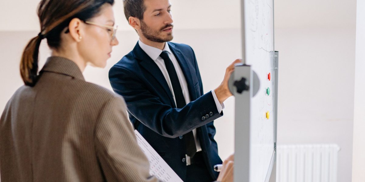 A team collaborating around a whiteboard, representing the process of evaluating options and making strategic decisions for AI platform selection.
