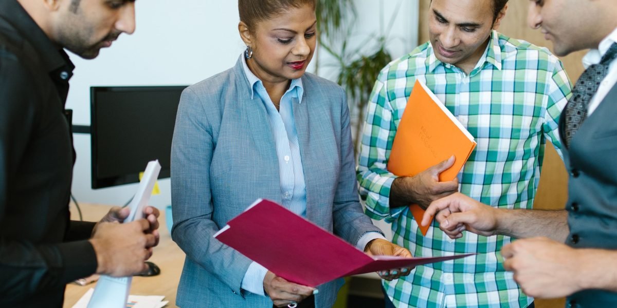 A diverse group of professionals engaged in a thoughtful discussion about ethical considerations in business, emphasizing responsible decision-making.
