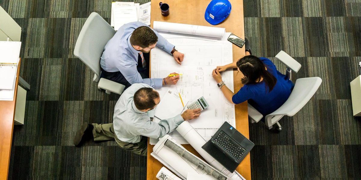 A diverse team in a meeting discussing legal documents, symbolizing the complexities of data handling and compliance.